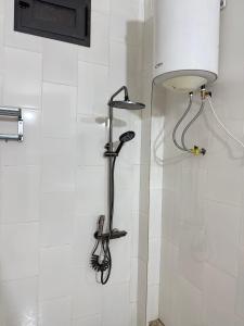 a shower in a bathroom with a shower head at Résidence NDAR CHAMBRES in Saint-Louis +29 photos