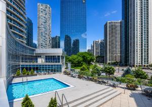 a pool in the middle of a city with tall buildings at Panoramic Lakeview Resort Living 3BDR with Gym, Pool, Free parking in Toronto