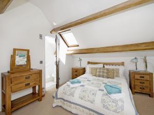 a bedroom with a bed and a mirror at Limber View in Glaisdale +8 photos