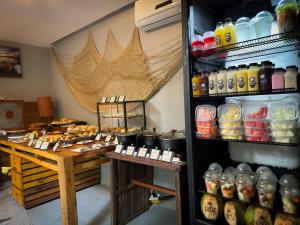 a room with a refrigerator filled with lots of drinks at Pousada Unaí in Porto De Galinhas