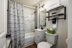 a small bathroom with a toilet and a shower at King Bed Studio-Downtown Getaway in Anchorage