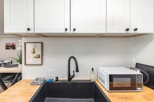 a kitchen with a sink and a microwave at King Bed Studio-Downtown Getaway in Anchorage