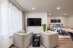 a living room with two chairs and a bed at King Bed Studio-Downtown Getaway in Anchorage +10 photos