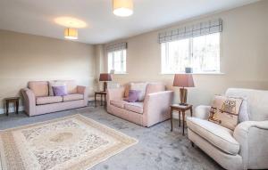 a living room with couches and chairs and a rug at The Dower House in Thorpeness