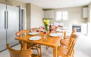 a dining room with a wooden table and chairs at The Dower House in Thorpeness