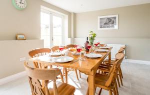 a dining room with a wooden table and chairs at The Dower House in Thorpeness +18 photos