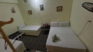 a small room with two beds and a chair at Magic View in Bine el Ouidane