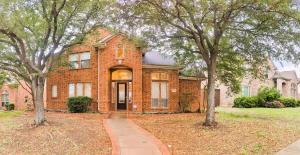 a brick house with trees in front of it at Elegant, comfy, a retreat with Pool in Garland
