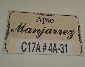 a sign that says apollo mannery on it at Apartamento Manjarrez 3 Compartido in Mompos