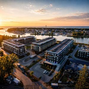 an aerial view of a city with buildings and a river at Sea View & SPA 10d10 in Dziwnów