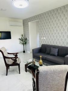 a living room with a couch and a table at Luma Residence in San Felipe de Puerto Plata