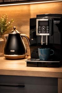 a coffee maker and a cup on a counter at Sea View & SPA 10d10 in Dziwnów