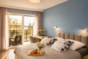 a bedroom with a bed with a tray of fruit on it at Sea View & SPA 10d10 in Dziwnów +43 photos