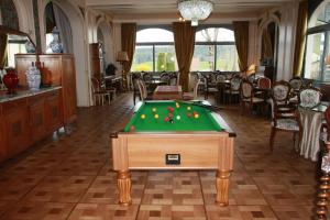 a room with a pool table with balls on it at Hôtel Beau Site in Malbuisson
