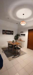 a dining room with a table and a potted plant at FS Homestay Cherating in Kuantan