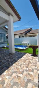 a patio with a table and a swimming pool at FS Homestay Cherating in Kuantan