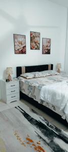 a bedroom with a bed and three pictures on the wall at FS Homestay Cherating in Kuantan +18 photos