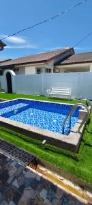 a swimming pool in the yard of a house at FS Homestay Cherating in Kuantan