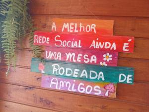 a group of signs hanging on a wall at Recanto do SOL in Imaruí