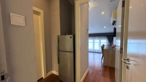 a kitchen with a stainless steel refrigerator in a room at Heritage Collection on Ann Siang - Mobile App Check-In in Singapore +6 photos