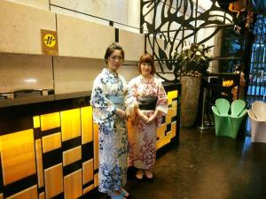 two women in kimonos are posing for a picture at The Cloud Hotel in Kaohsiung