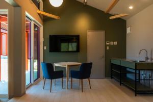 a kitchen with a table and chairs and a sink at Asahi Shizenkan in Asahi-machi