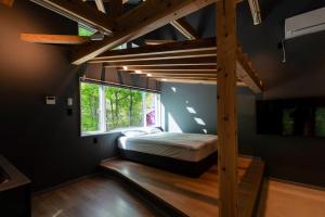 a bedroom with a loft bed and a window at Asahi Shizenkan in Asahi-machi