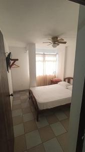 a bedroom with a bed and a ceiling fan at Hosp Norte Los Organos in Los Órganos