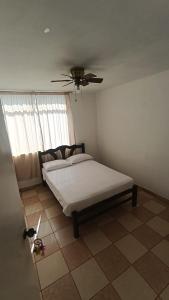 a bedroom with a bed and a ceiling fan at Hosp Norte Los Organos in Los Órganos
