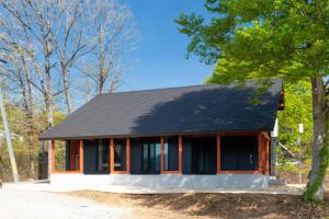 a small house with a black roof at Asahi Shizenkan in Asahi-machi