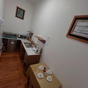 a small kitchen with a table and a counter top at Núba Hospedaje in Baños +3 photos