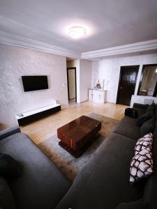 a living room with a couch and a coffee table at Cozy Beach Apartment Diar Mansour Rabat in Rabat