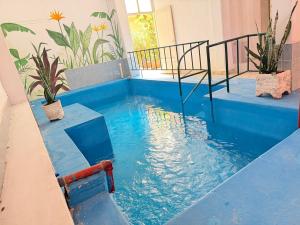 a swimming pool with blue water in a house at Malibu in Termas de Río Hondo
