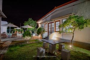 a table in the yard of a building at night at Wild Le Green in Udawalawe