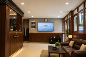 a living room with a couch and a flat screen tv at Second Home Hotel in Kathmandu