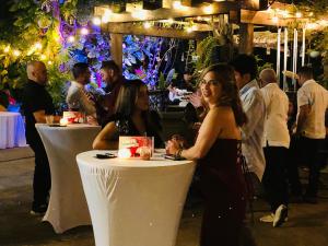 a group of people sitting at tables at a party at Villa Vassallo in Ponce +78 photos