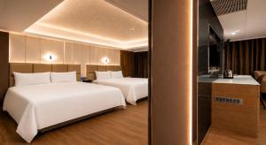 a hotel room with two beds and a kitchen at The Cloud Hotel in Kaohsiung