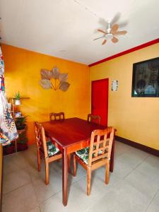 a dining room with a wooden table and chairs at Tugbongan North Siargao in Burgos +20 photos