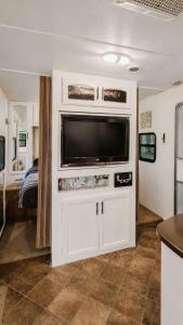 a large white entertainment center with a tv in a room at 2-bedroom Camper Trailer Cottage #3 in Dillon