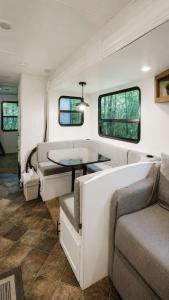 a living room with a couch and a table at 2-bedroom Camper Trailer Cottage #3 in Dillon