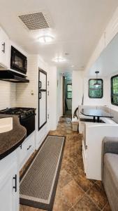 a kitchen and living room of a recreational vehicle at 2-bedroom Camper Trailer Cottage #3 in Dillon