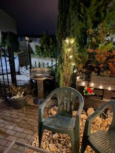 two chairs and a table and a bench in a garden at Apartmán Mirka in Nový Šaldorf