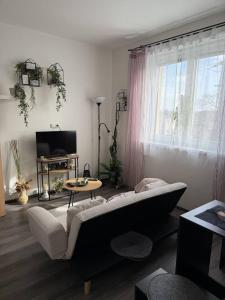 a living room with a couch and a table at Apartmán Mirka in Nový Šaldorf