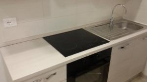 a kitchen with a sink and a stove at Piazzetta dei Consoli Apartment in Savona +37 photos