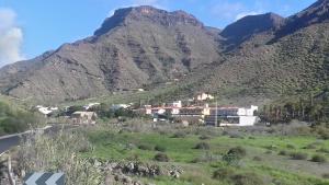 a village in the mountains with a mountain at Mogan Valle Cercado in Mogán