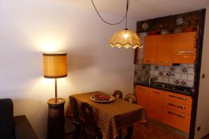 eine Küche mit einem Tisch mit einer Lampe und einem Tisch mit einer Platte in der Unterkunft House Driade by Holiday World in Sauze dʼOulx