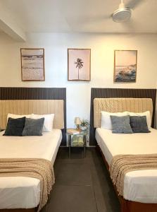 a hotel room with two beds and a table at Casa Alma de Mar in Brisas de Zicatela
