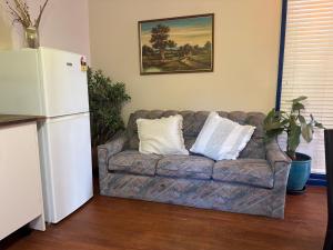 a living room with a couch with two pillows on it at Sweet home in Goodwin Hill in Macgregor