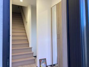 a hallway with a staircase leading up to a room at Osaka Convenient Location Entire Private Second Floor in Hirakata