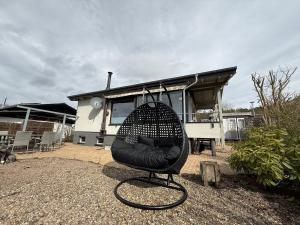 a black chair sitting in front of a house at Apartment im Heidchen in Knüllwald